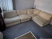 Four-piece Arconas sectional sofa arranged in an L-shape against wall
