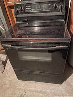 Full view of black KitchenAid oven showing electric smooth top stove and front panel.