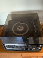 Top view of Zenith record player with transparent dust cover showing turntable and front controls.