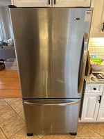 Front view of stainless steel refrigerator with freezer drawer closed