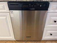 Front view showing stainless steel door, integrated handle and top control panel