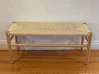 Front view showing full bench frame and woven seat