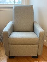 Front view of grey herringbone upholstered glider chair