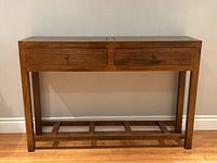 Full front view of console table showing two drawers and lower shelf