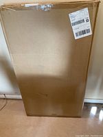 Sealed original cardboard box containing the futon mattress showing shipping label and box condition.