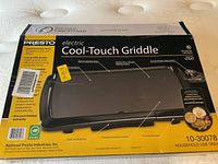 Box for Presto electric Cool-Touch Griddle showing front and product features with measurements 10.5 x 16 inches.
