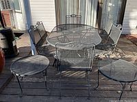 Overview of table, four chairs, loveseat bench, two side tables on deck