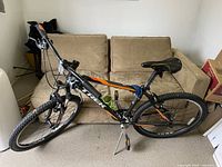 Side view of Trek mountain bike showing overall structure, tires, saddle, and handlebars.