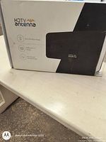 Box showing the HDTV antenna brand and key features such as 30 mile range, 1080p HD TV output, and new extension transmission technology.