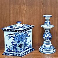 Photo showing both the diamond-shaped ceramic ginger jar canister and blue and white candlestick together