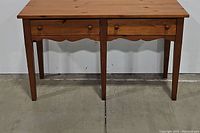 Front view of Broyhill wood entry table showing two drawers and wood finish.