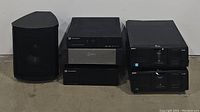 Group view of all six components including subwoofer at left, three stacked audio components in middle, two Sony CD changers at right