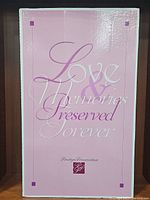 Pink box with 'Love & Memories Preserved Forever' text, indicating preservation by Prestige Preservation.