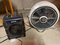 Photo showing both the Turbo-Aire fan and the Mastercraft heater side by side on a concrete floor in a basement area.