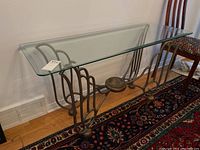 Full side view of rectangular glass top and metal base