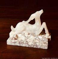 Front angled view of the alabaster antelope cigar ashtray showing carved figure and marble base.