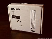 Box showing 'HOLMÖ' branding with lamp silhouette and product details.