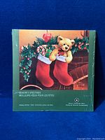 Front view of the Holiday Gift Set packaging showing a Christmas scene with stockings and teddy bear.