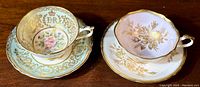 Two Paragon teacup and saucer sets side by side showing designs and condition.