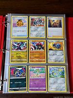 Photo of binder page showing nine different Pokémon cards including Leavanny, Klang, Croagunk, Togedemaru