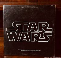 Front of the black album cover with large white Star Wars logo.