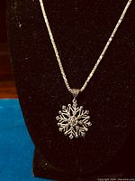 Close-up of the sterling silver marcasite snowflake pendant on black display showing detailed marcasite stones and snowflake shape