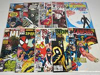 Lot of 10 Marvel comic books displayed on a surface, each in poly sleeves with backer boards. Comics include Fantastic Four, Wolverine, Moon Knight, Spider-Man, X-Men, Quasar, and others. Covers feature vibrant Marvel art.