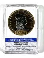 Obverse side of the 1797 Turban Head Gold Eagle replica coin showing Liberty profile with turban headpiece and date 1797, encased in plastic holder with description label.