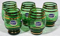 Group of five green and gold liqueur glasses showing original Bohemia Glass stickers