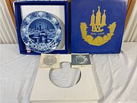 Collector plate inside original blue presentation box with gold Bing & Grondahl 1895-1995 emblem, certificate, informational leaflet, and custom cut foam insert.