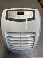 Front view of LG portable air conditioner showing control panel and air vents.