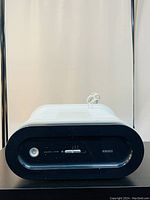 Front view of the HoMedics AR-10 air purifier showing the control panel with power button, mode selector, and brand name.