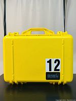 Closed yellow Pelican 1500 case with handle and label visible on front.