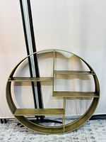 Front view of round floating shelf with compartments