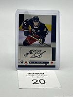Front view of 2005-06 Upper Deck Be a Player autographed hockey card of Andrew Cassels in Blue Jackets uniform, displayed in a protective sleeve.