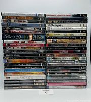 Photo showing the stacked sealed DVD cases with visible titles arranged in rows.