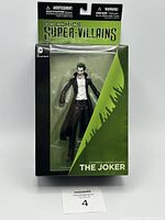 Front view of The Joker action figure in original DC Comics Super-Villains packaging showing character details and packaging design.