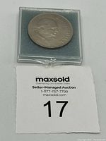 Top and side view of the 1965 Great Britain 1 Crown coin featuring Winston Churchill in a protective plastic case with blue foam base.