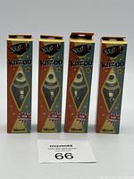 Four Neat O! Metal Kazoos packaged in original individual boxes with visible product through diamond-shaped window.