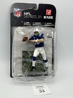 Front view of Peyton Manning action figure in packaging, showing figure in Colts blue and white uniform with football in throwing position.