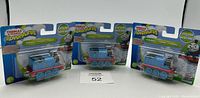 Three Thomas & Friends Adventures Thomas train figures in original packaging, arranged on a white background