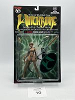 Front image of the Top Cow Medieval Witchblade action figure in original sealed packaging. Shows figure with armor, spear, shield, and stand.