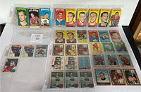 Photo of the full collection of 29 vintage hockey cards laid out on a white surface, confirming quantity and general condition