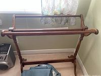 Front view of the wooden blanket rack showing its structure and design.