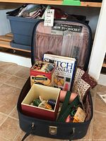 Full view of fabric case holding sewing notions, thread, and crafting books.