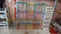 Full view of multicolor modular wire shelving unit with attached white six-drawer plastic storage organizer.