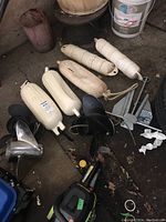 Assorted boat fenders, propellers, anchor on shed floor