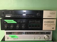 Front view of stacked Pioneer and Sanyo stereo units showing tuner, cassette player, and amplifier controls.