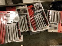 Top-down view of multiple Jobmate file sets still sealed in original packaging showing the layout of assorted files and handles.