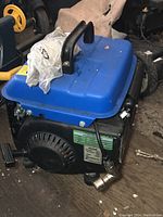 Side view of the TQ TG1200 generator showing blue fuel tank and pull start on engine casing.